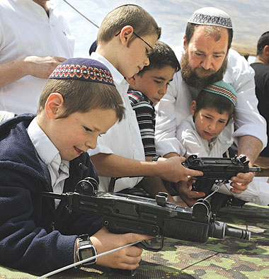 Settlers teach their kids how to use guns